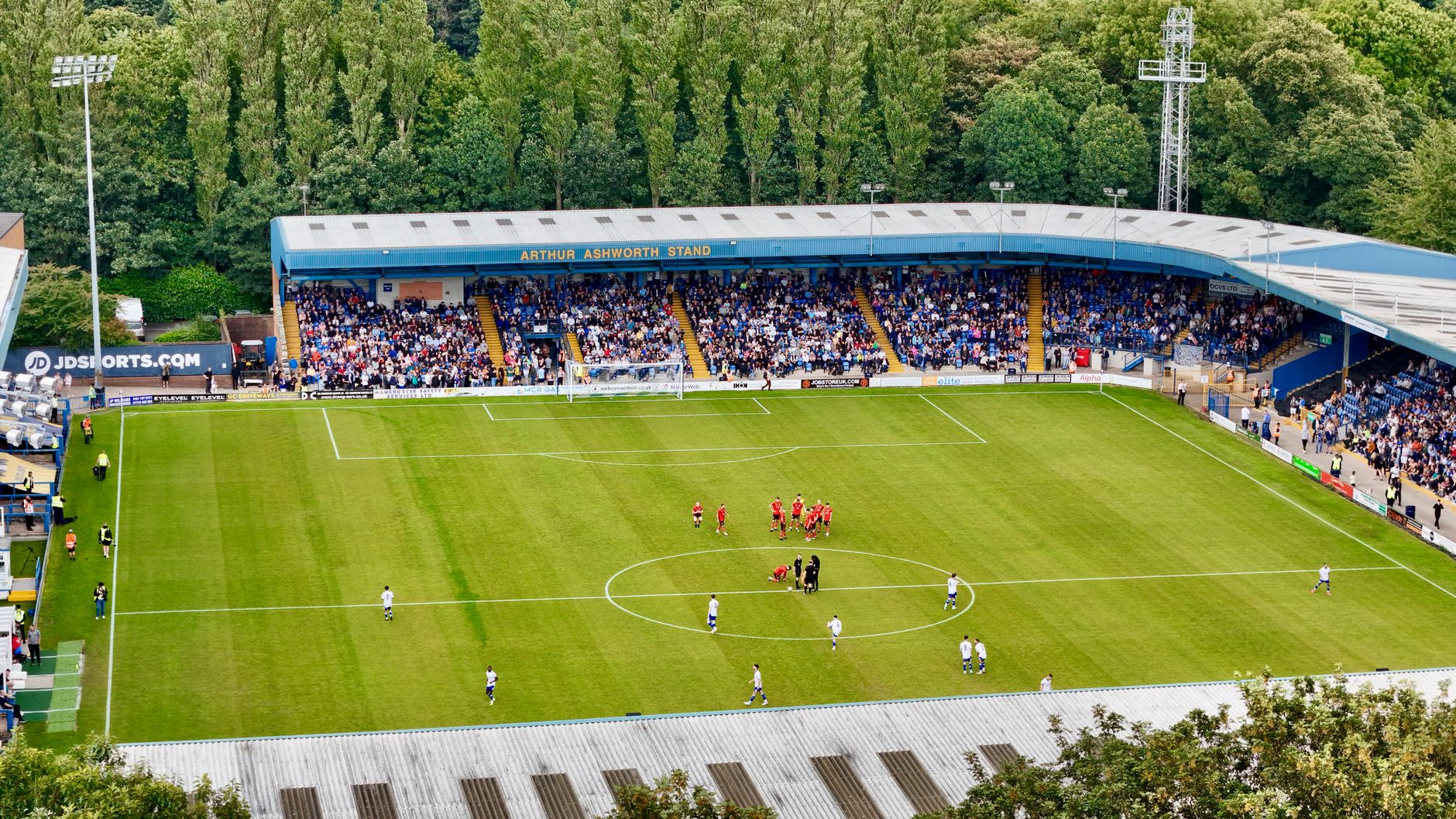 An aerial view of a football match in progress at Bury's Arthur Ashworth Stand.