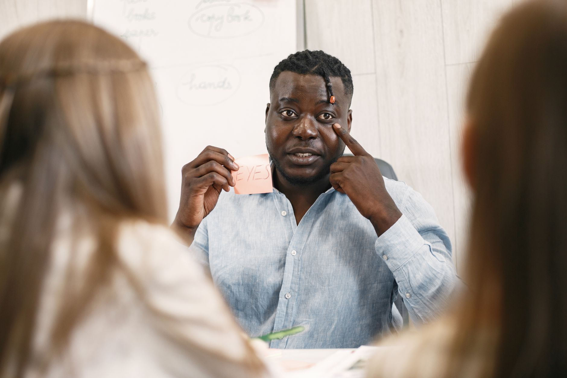 Teacher uses interactive methods to teach students in a classroom setting, promoting active learning.