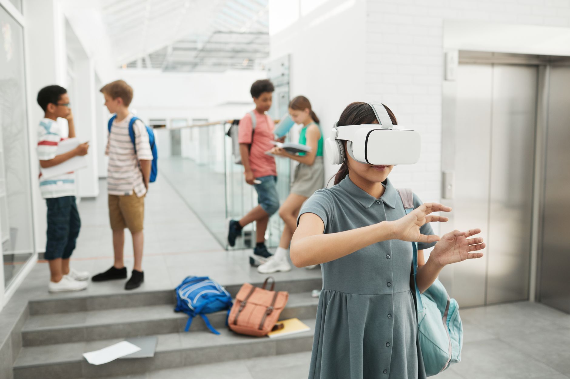 Group of students exploring virtual reality technology at a modern school setting.